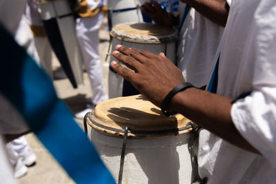 Members of the group filhos de gandhy are seen playing percussion during a tribute to santa luzia