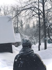 Rear view of person on snow covered field