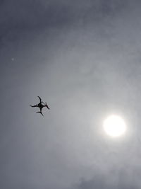 Low angle view of silhouette spider against sky