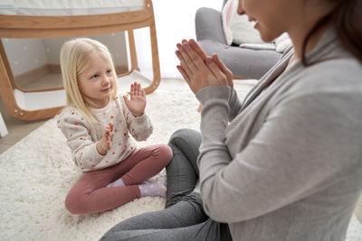 Mother and daughter playing at home