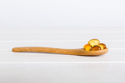 Close-up of wooden spoon on white background