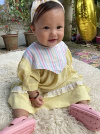 High angle view of cute baby girl on bed