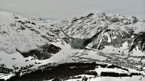 Scenic view of snow covered mountains against sky