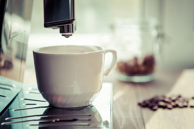 Espresso coffee preparation on a wooden table