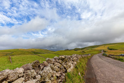 Empty road along countryside landscape