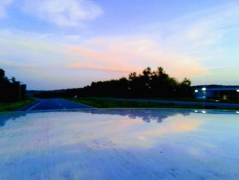 Scenic view of lake against sky at sunset