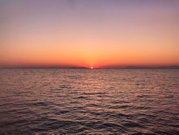 Scenic view of sea against romantic sky at sunset