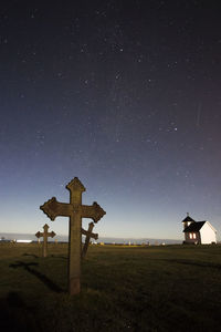 Lifeguard hut on field against sky at night