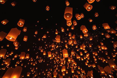 Low angle view of illuminated paper lanterns at night