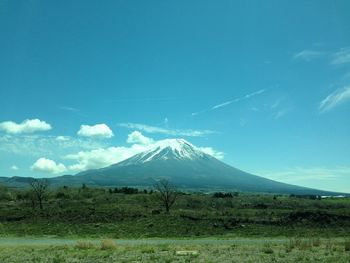 Scenic view of snowcapped mountains against blue sky