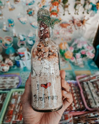 Close-up of hand holding bottle