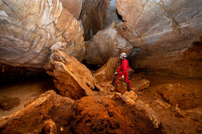 Rear view of man standing on rock formations