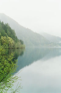 Scenic view of lake and mountains against clear sky