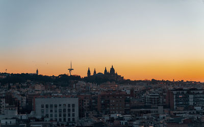 City against sky during sunset