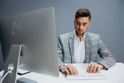 Businesswoman using laptop at office