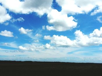 Scenic view of landscape against cloudy sky