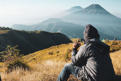 Rear view of man standing on mountain