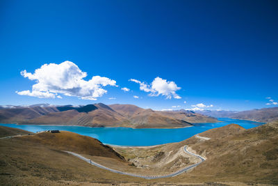 Panoramic view of landscape and mountains against blue sky