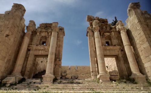 Low angle view of old ruins against sky