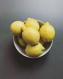 High angle view of fruits in bowl against black background