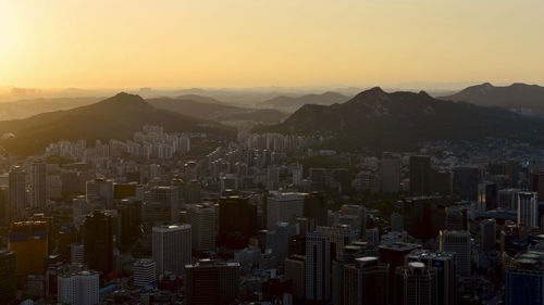 High angle view of buildings in city against sky during sunset