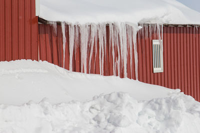 Icicles hanging on a barn roof.