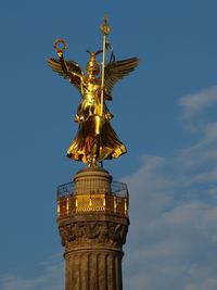 Low angle view of statue of liberty against sky