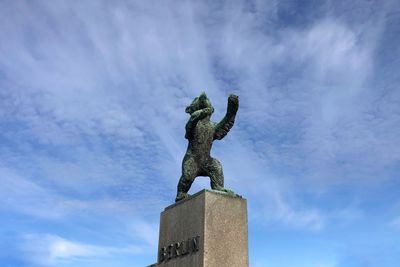 Low angle view of statue against blue sky