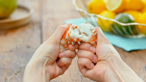 Cropped hand of person holding shrim on hand