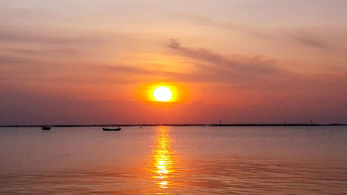 Scenic view of sea against romantic sky at sunset