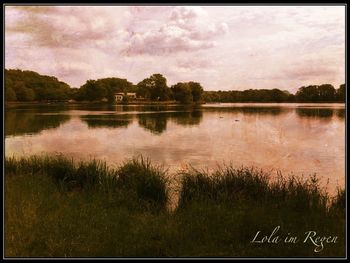 Scenic view of lake against cloudy sky