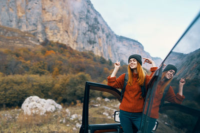 Young woman standing on mountain road