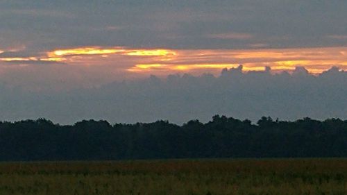 Scenic view of landscape against sky at sunset