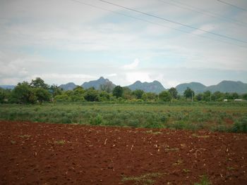 Scenic view of mountains against cloudy sky