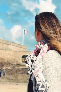 Rear view of woman against cloudy sky