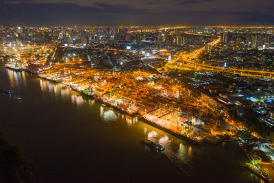 High angle view of illuminated buildings in city at night