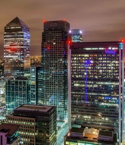 Illuminated cityscape against sky at night