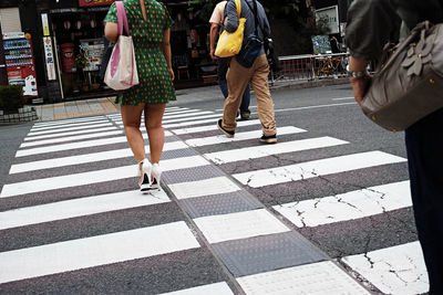 Low section of women walking on city street