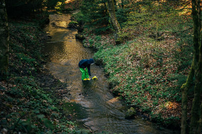 Rear view of man walking on footpath