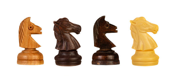 Close-up of chess pieces against white background