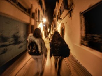 Blurred motion of woman at night