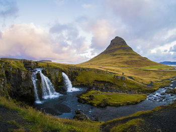 Scenic view of waterfall against sky