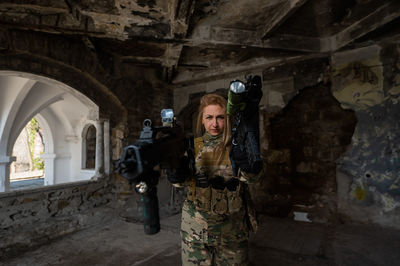 Rear view of woman standing against wall