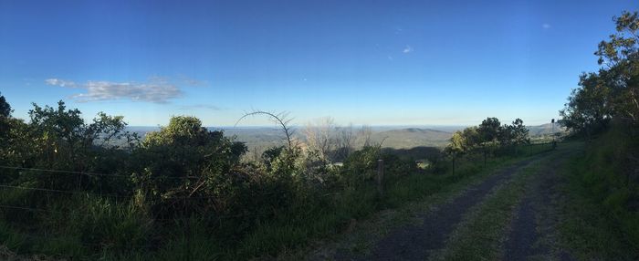 Scenic view of landscape against blue sky