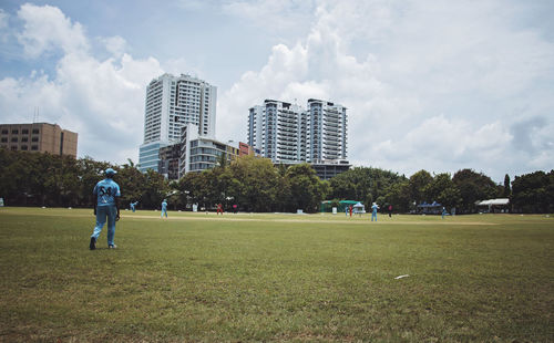 Man standing on field against sky