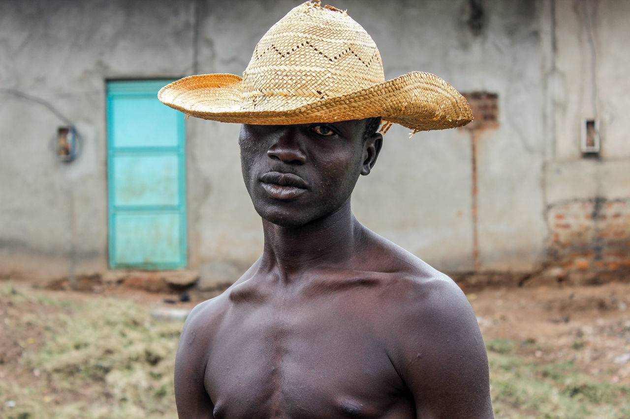 shirtless, one person, hat, portrait, lifestyles, clothing, real people, front view, focus on foreground, headshot, men, young adult, standing, young men, day, leisure activity, adult, males, looking, chest