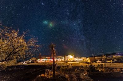 Scenic view of field against star field at night