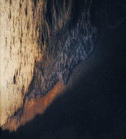 High angle view of sea shore against sky at sunset