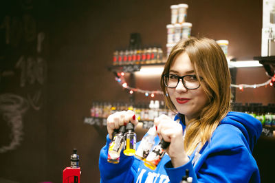 Portrait of young woman standing in store