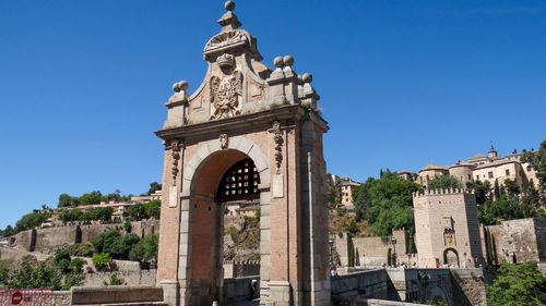 Low angle view of historical building against blue sky